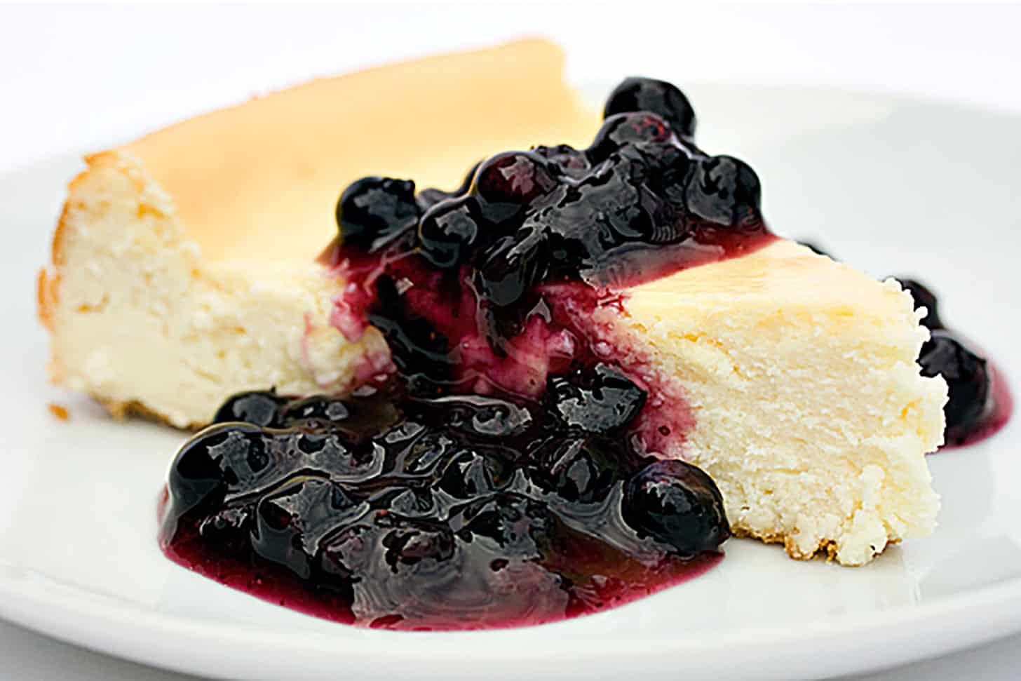 classic cheesecake topped with blueberry sauce