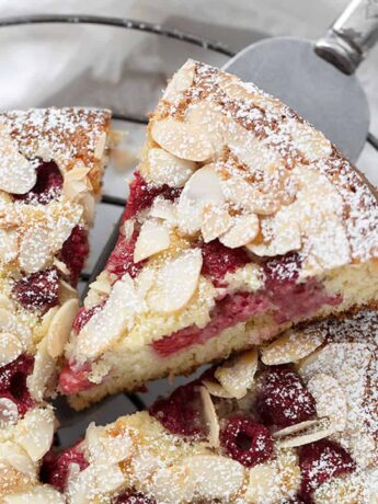 raspberry buttermilk cake sliced on cooling rack