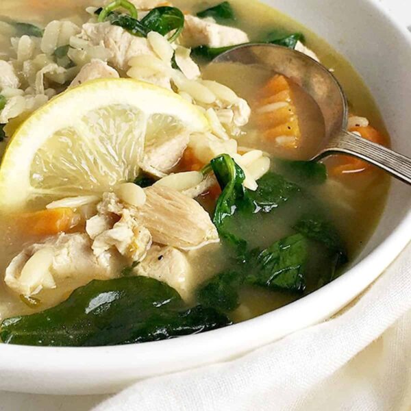 chicken orzo lemon soup in white bowl