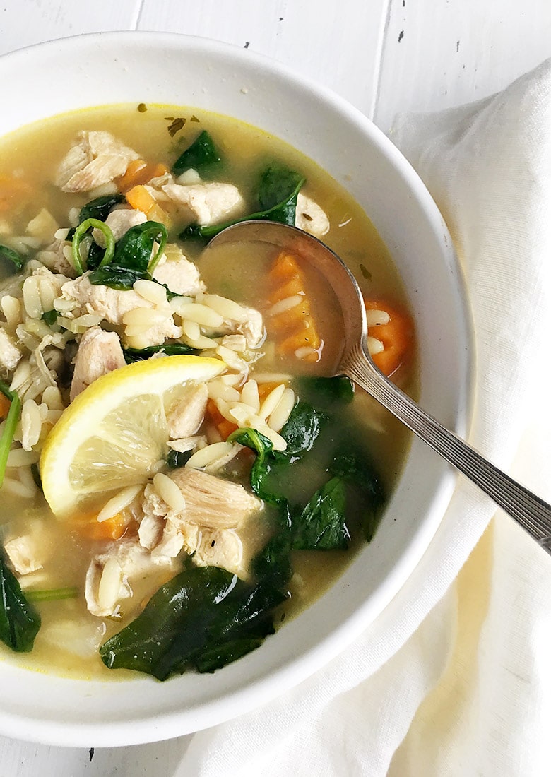 chicken orzo soup in white bowl