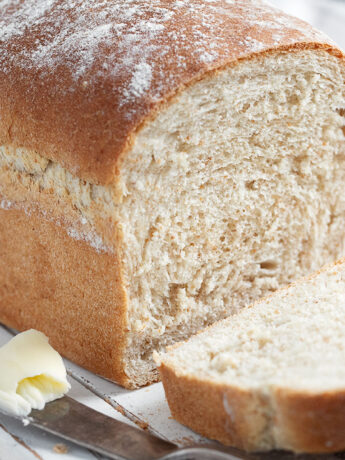 honey whole wheat bread sliced on cutting board