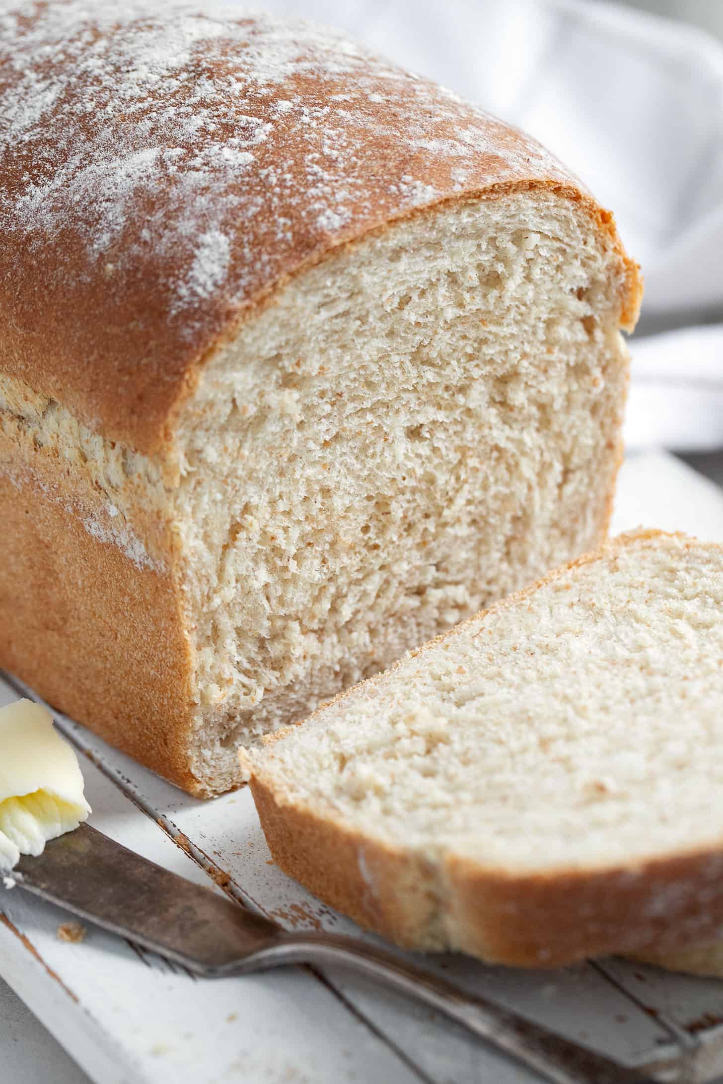 honey whole wheat bread sliced on cutting board