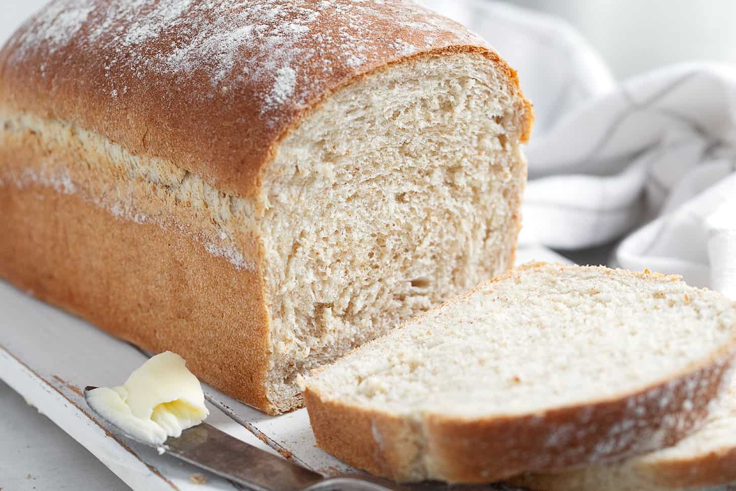 honey whole wheat bread sliced on cutting board