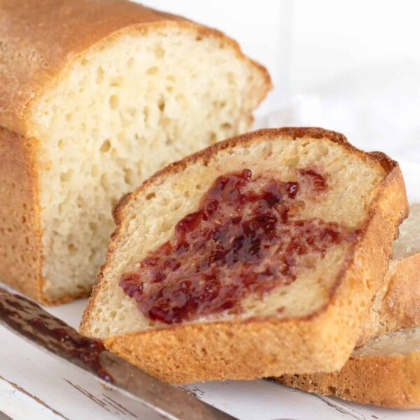 english muffin bread sliced with butter and jam