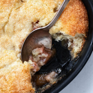 rhubarb cobbler in baking dish with spoon