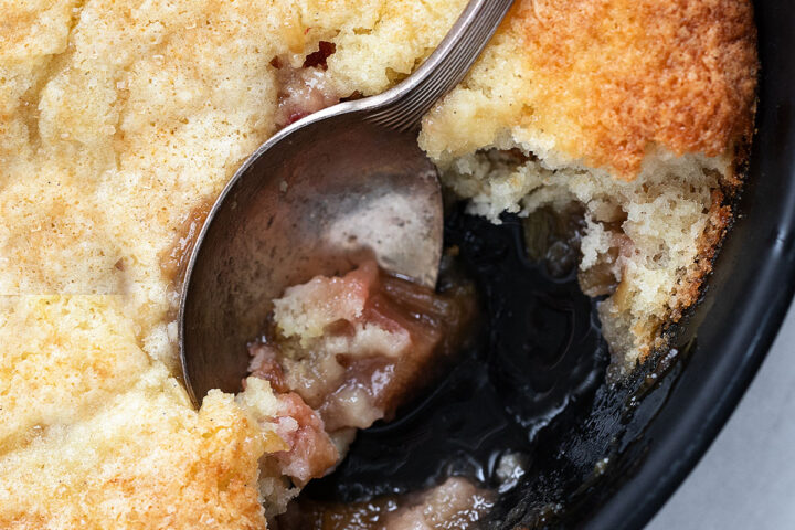 rhubarb cobbler in baking dish with spoon