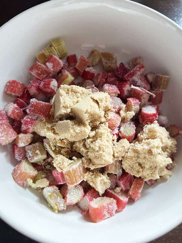 frozen rhubarb and brown sugar in bowl