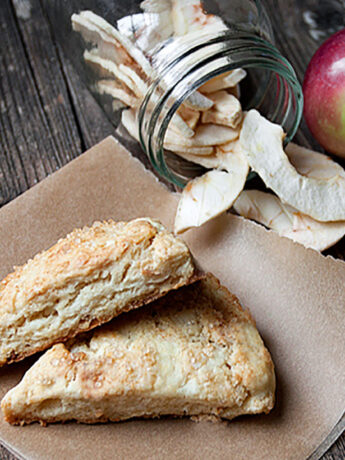 dried apple scones on parchment paper with dried apples and apple
