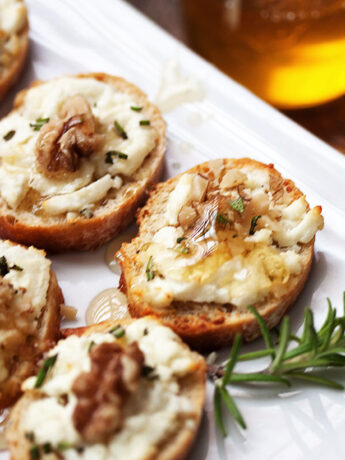 goat cheese crostini with walnuts and honey on serving platter