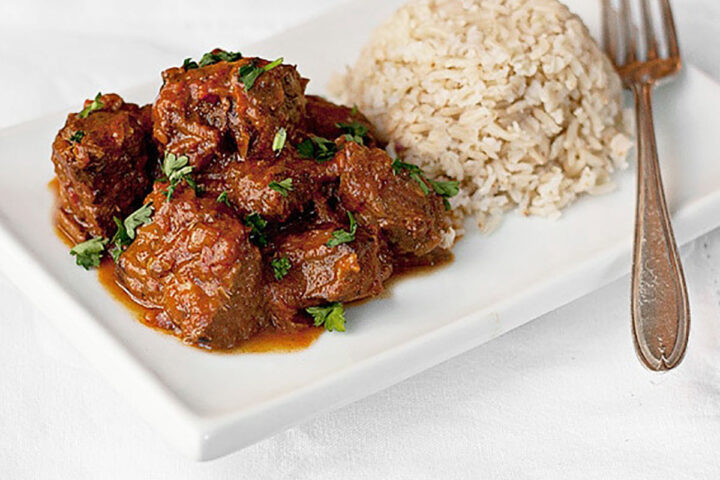 beef curry on plate with rice and fork