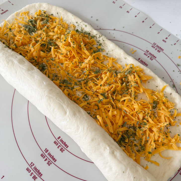 Rolling up the filled dough jelly-roll style.