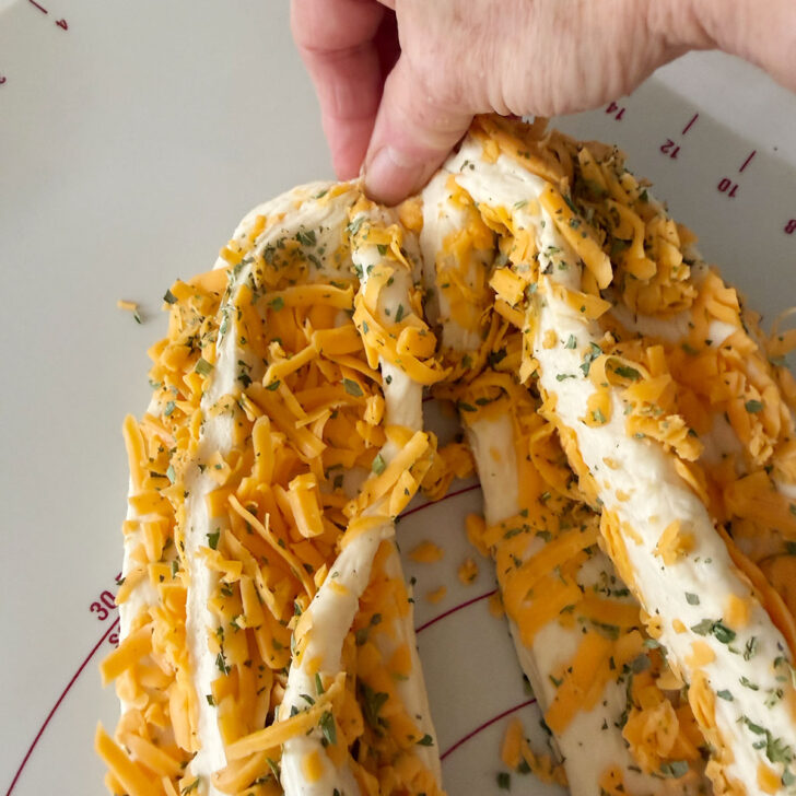 Pinching the two pieces of dough together.