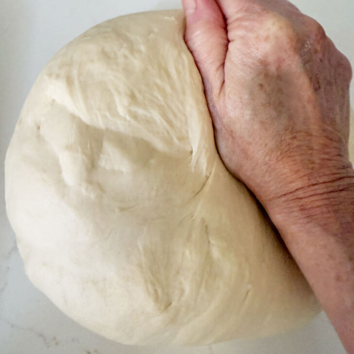 Kneading the finished dough on the counter.