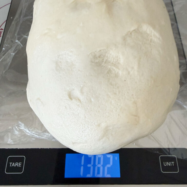 Weighing the dough on a kitchen scale.