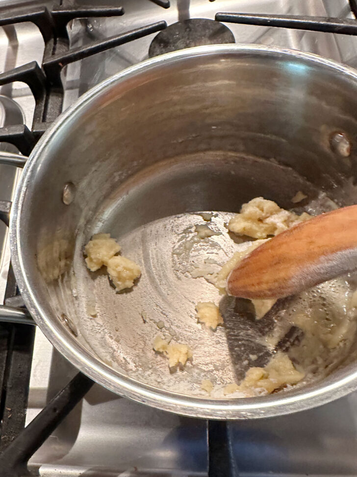 Stir together butter and flour in pan