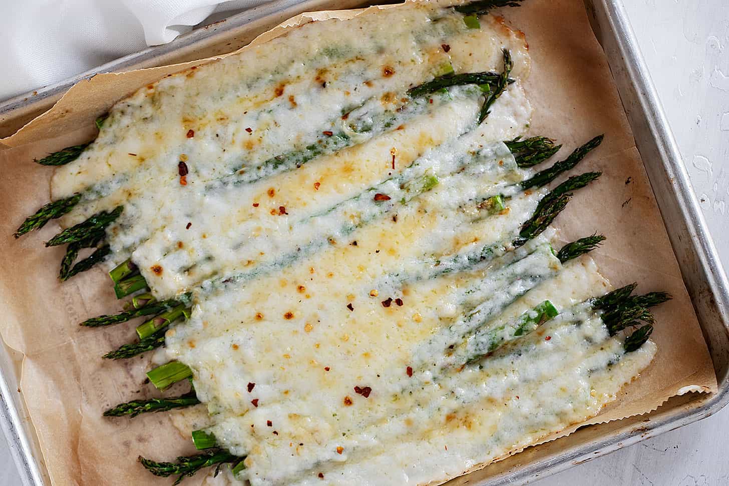 creamy asparagus on baking sheet