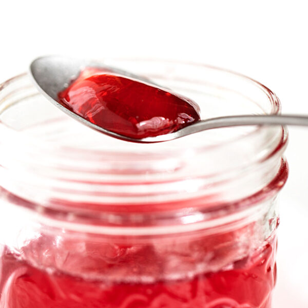 homemade crab apple jelly in jar with some on spoon
