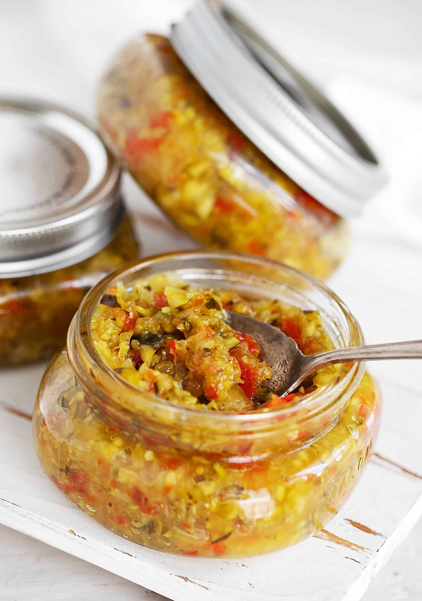 zucchini relish in jars with spoon