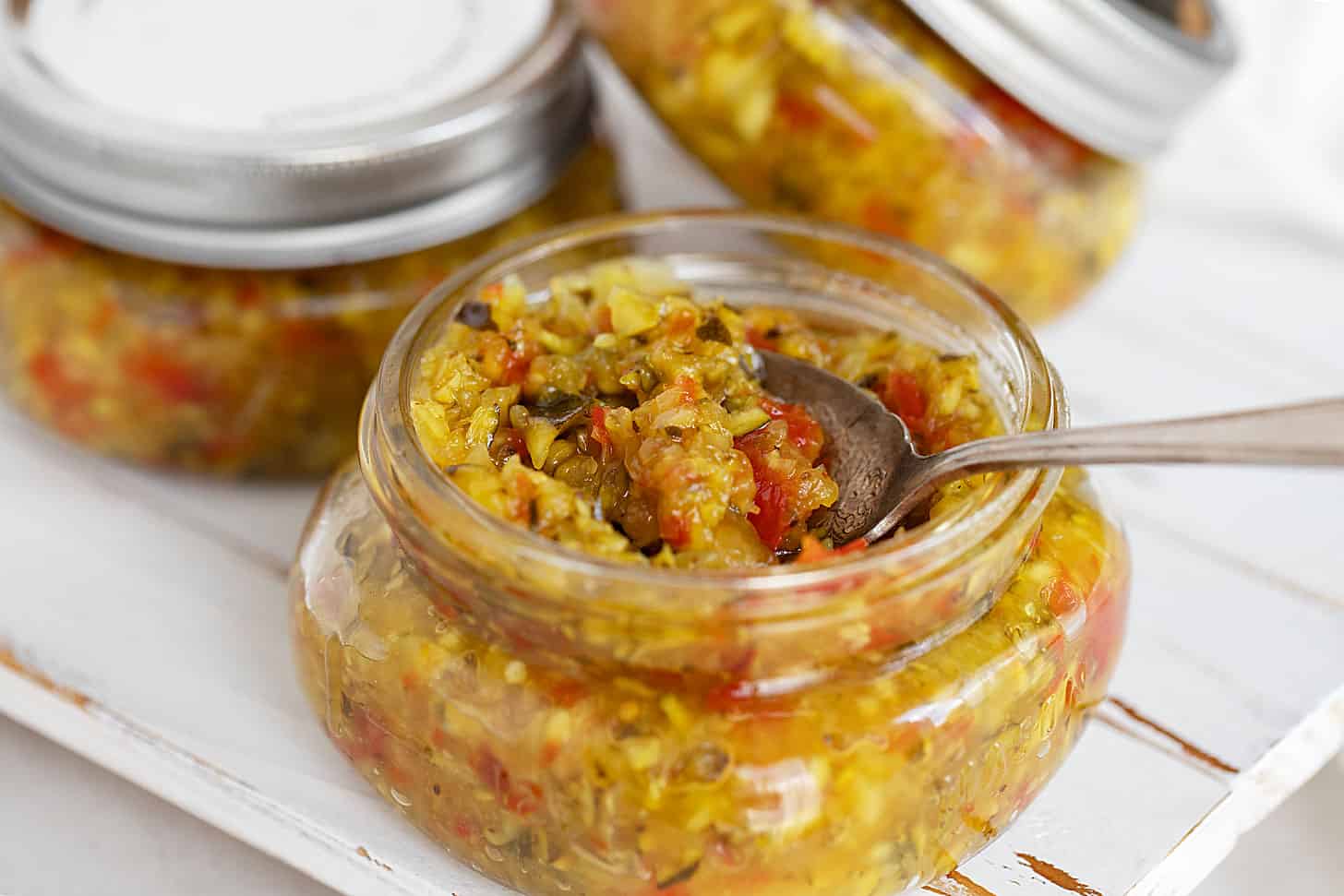 zucchini mustard relish in jars with spoon