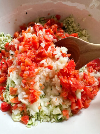 chopped zucchini red pepper and onion in bowl
