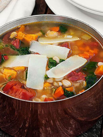 harvest vegetable soup in copper pot