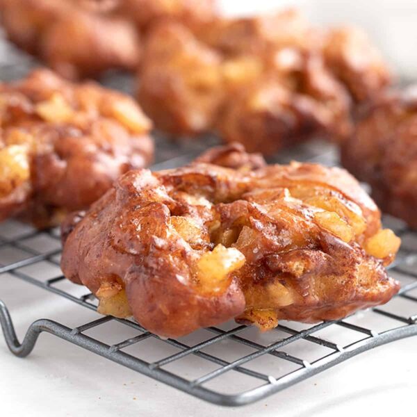 apple fritter yeast doughnuts on cooling rack