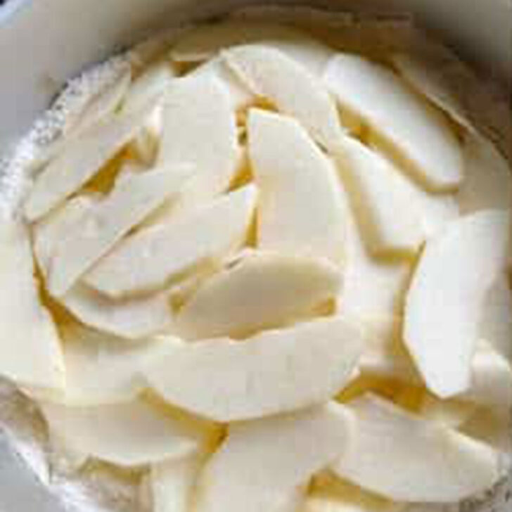 Sliced apples added to the pan.