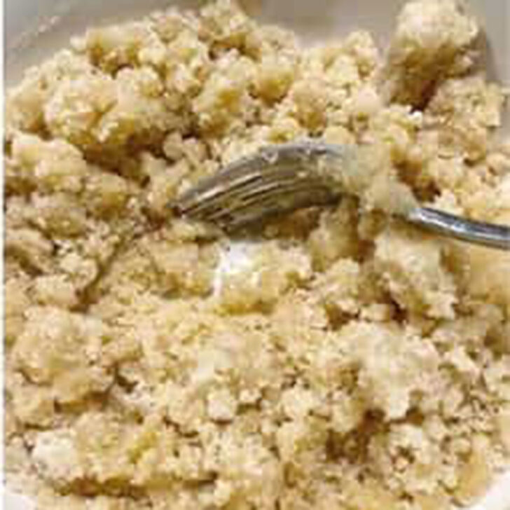 Mixing up the crumble mixture in a bowl.