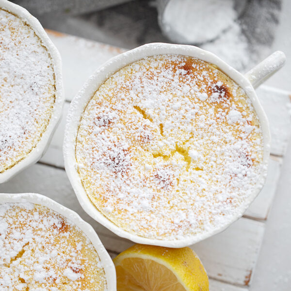 Lemon pudding cakes on a serving stand.
