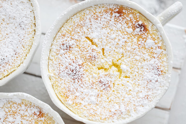 Lemon pudding cakes on a serving stand.