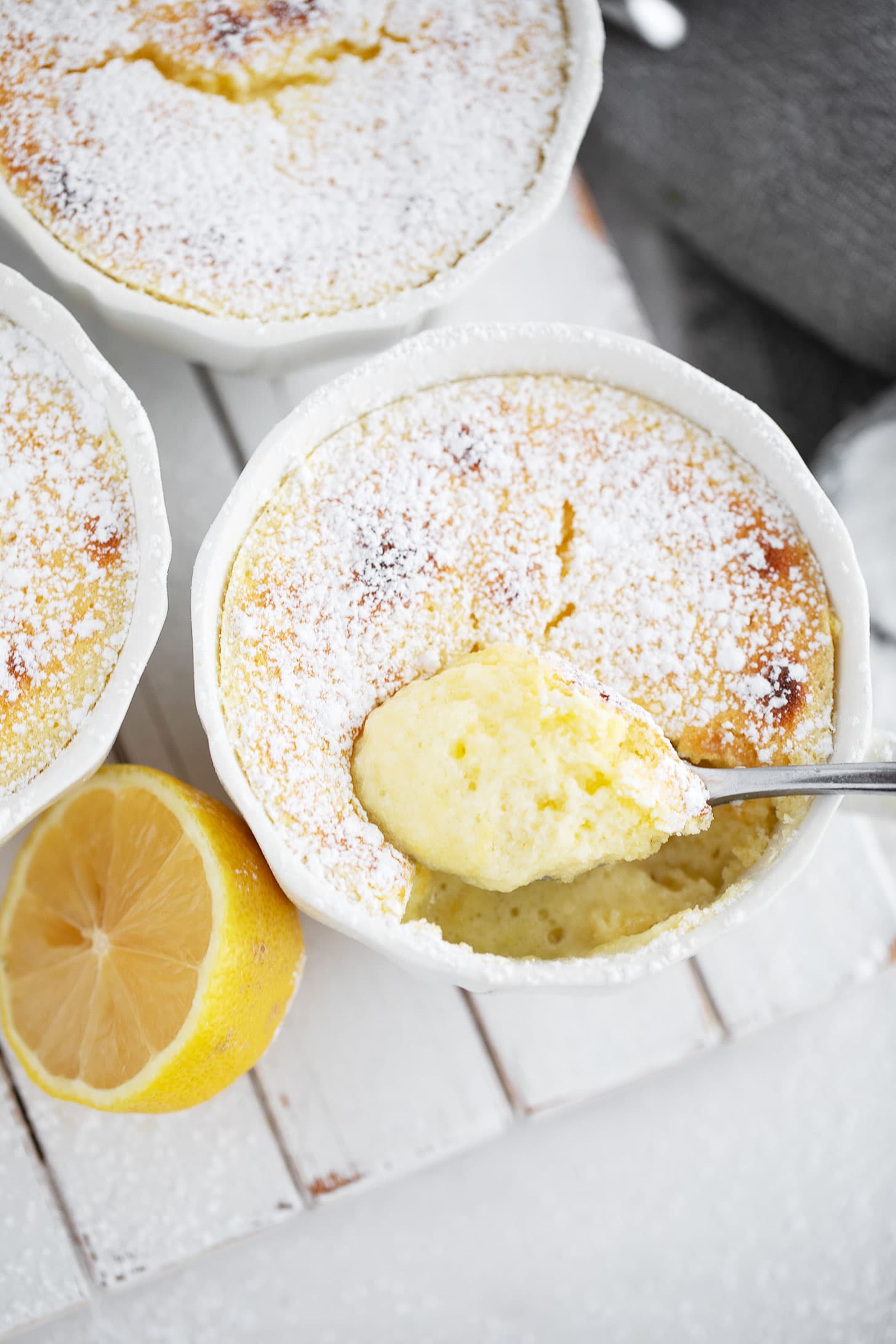 Lemon pudding cakes on a serving stand.