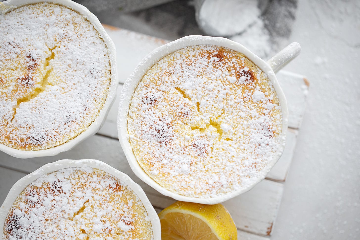 Lemon pudding cakes on a serving stand.