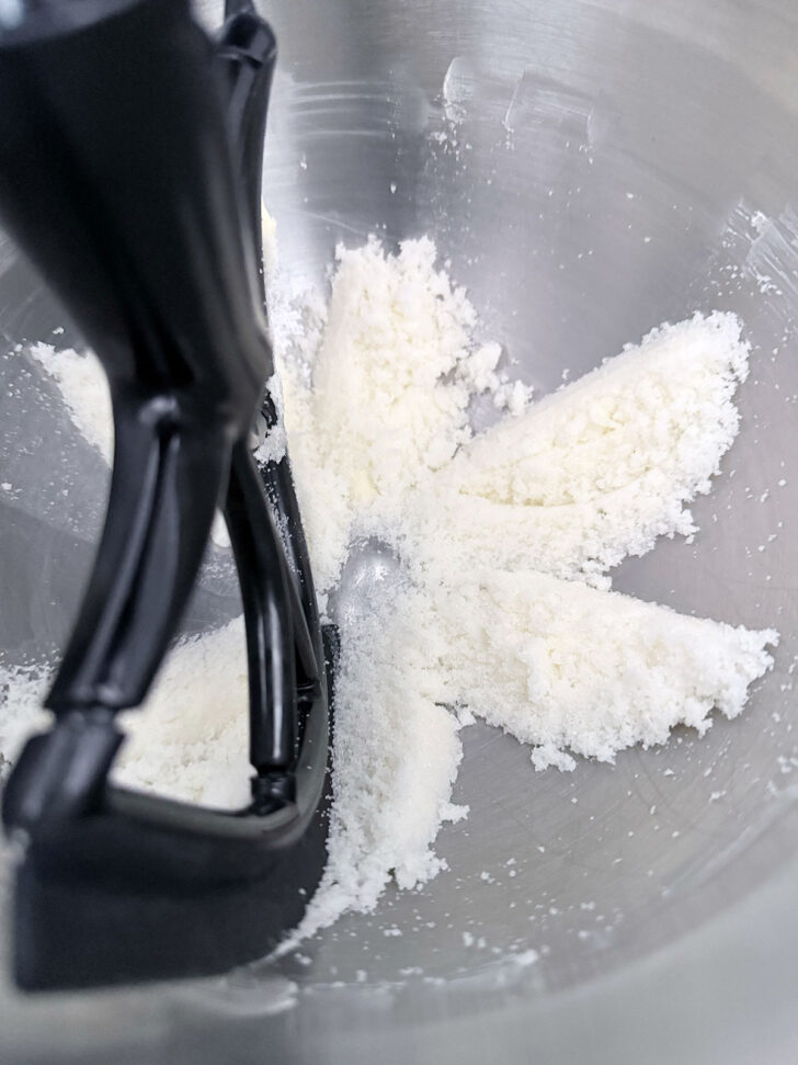 Butter and sugar mixed together in a stand mixer bowl.