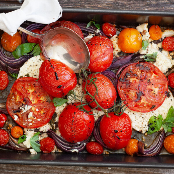 roasted tomatoes and feta in baking pan