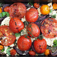 roasted tomatoes and feta in roasting pan