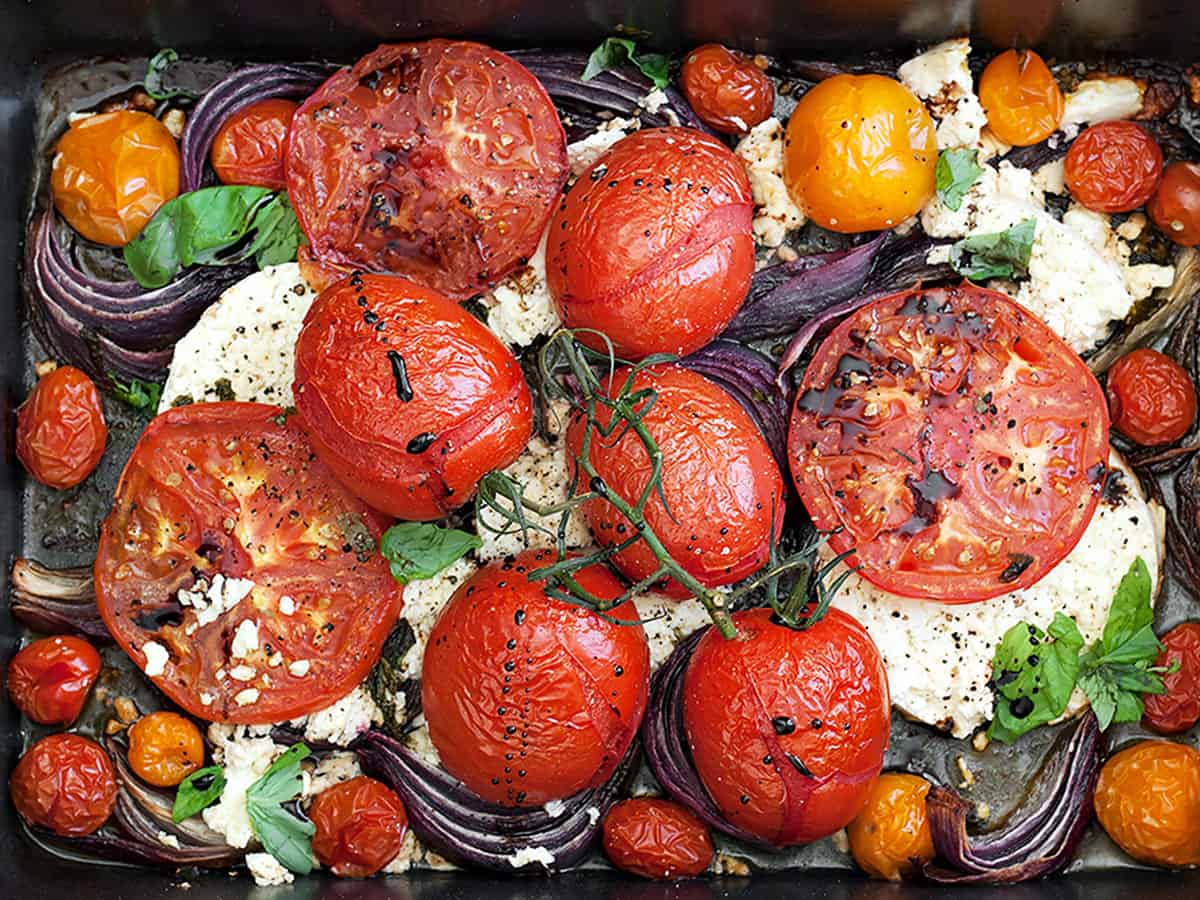 roasted tomatoes and feta in roasting pan