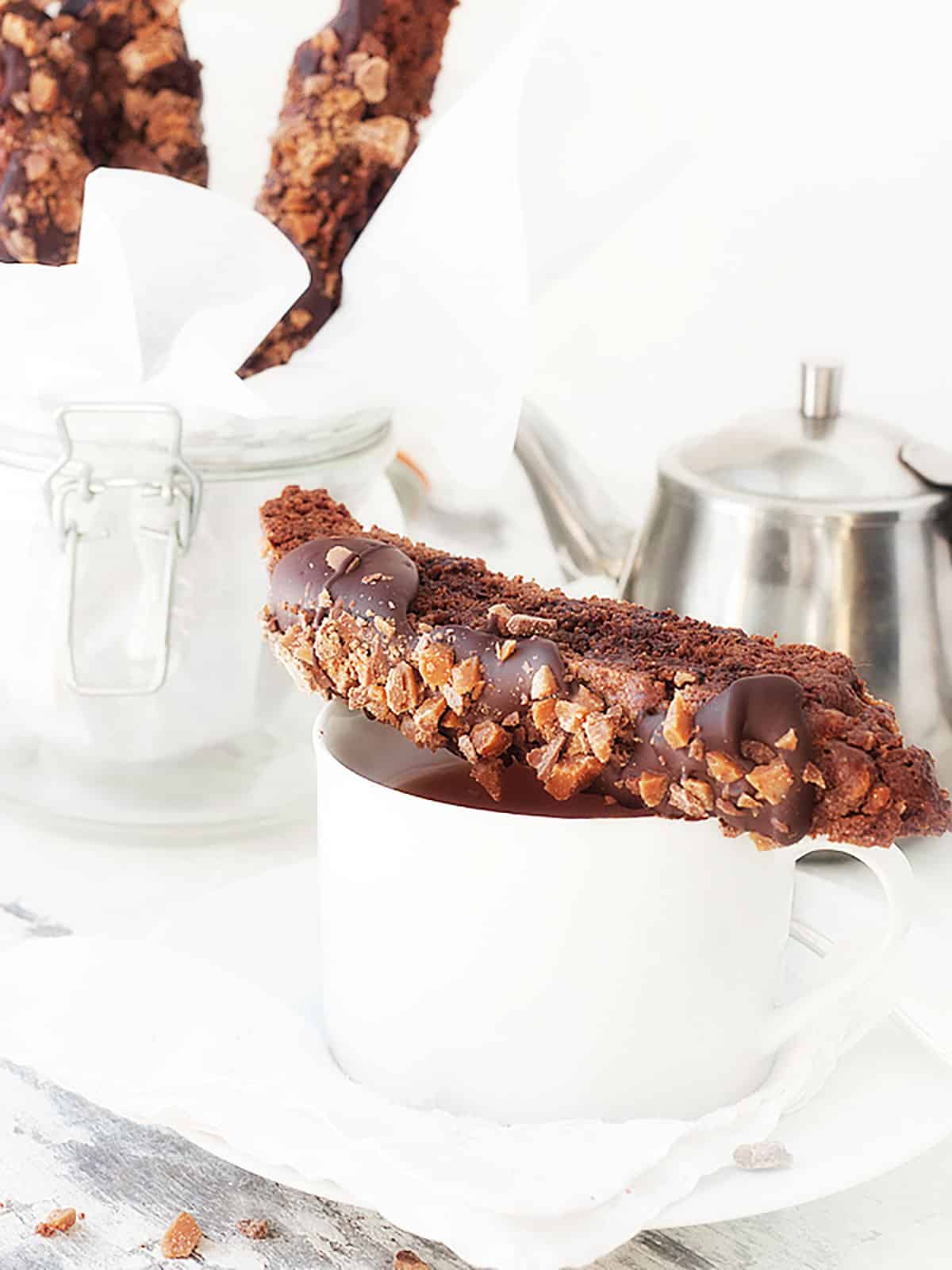 double chocolate toffee biscotto on top of coffee cup