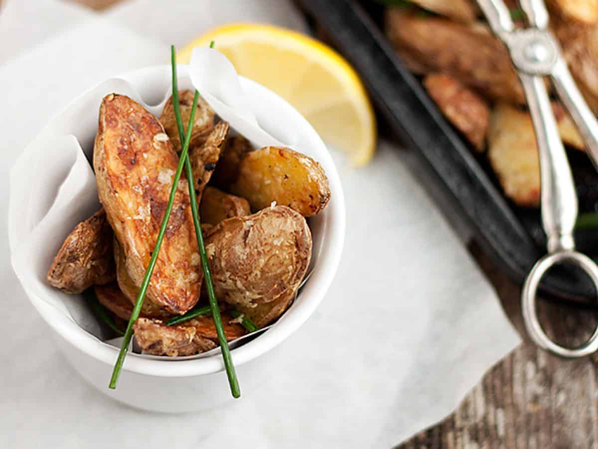 parmesan fingerling potatoes in bowl and on baking sheet