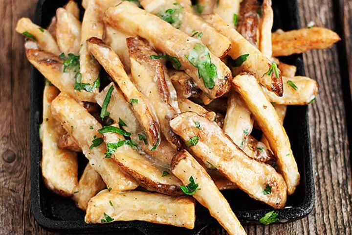 oven baked fries with cheese and gravy in small skillet