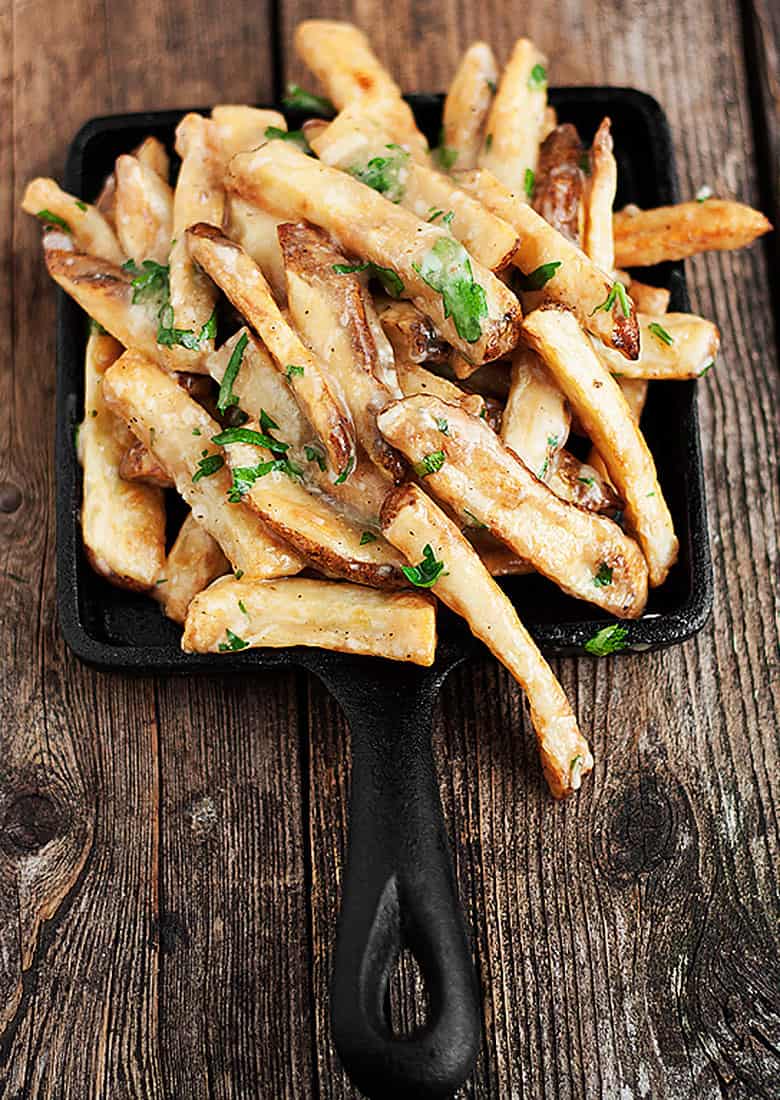 oven baked fries with cheese and gravy in small skillet