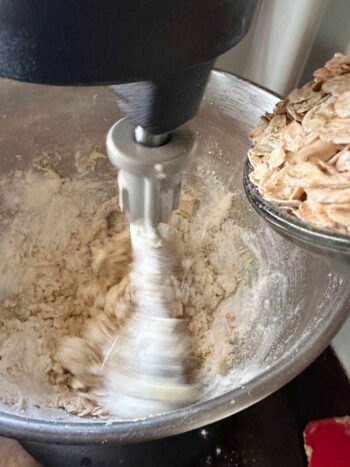 adding rolled oats to dough