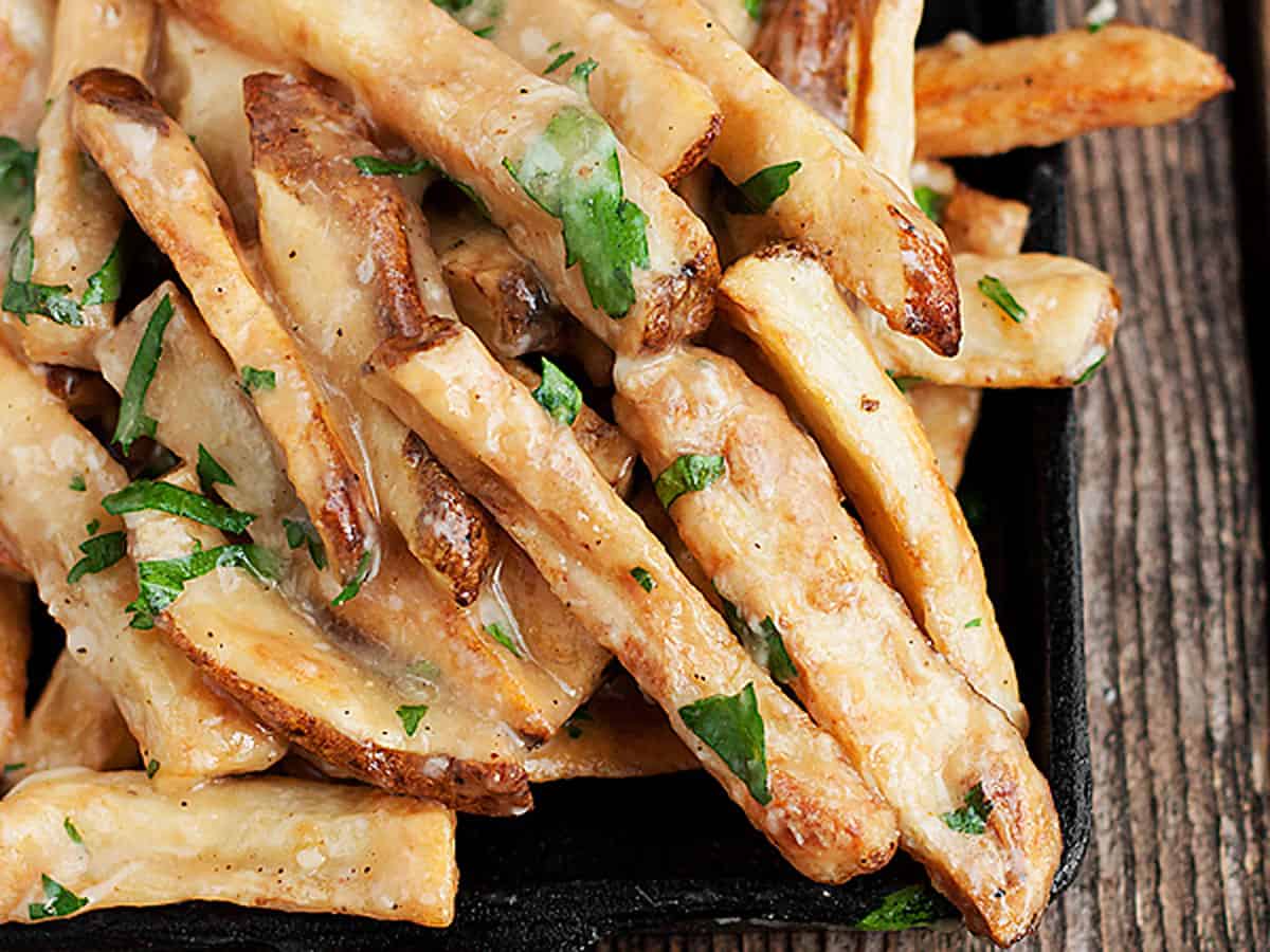 oven baked fries with cheese and gravy in small skillet