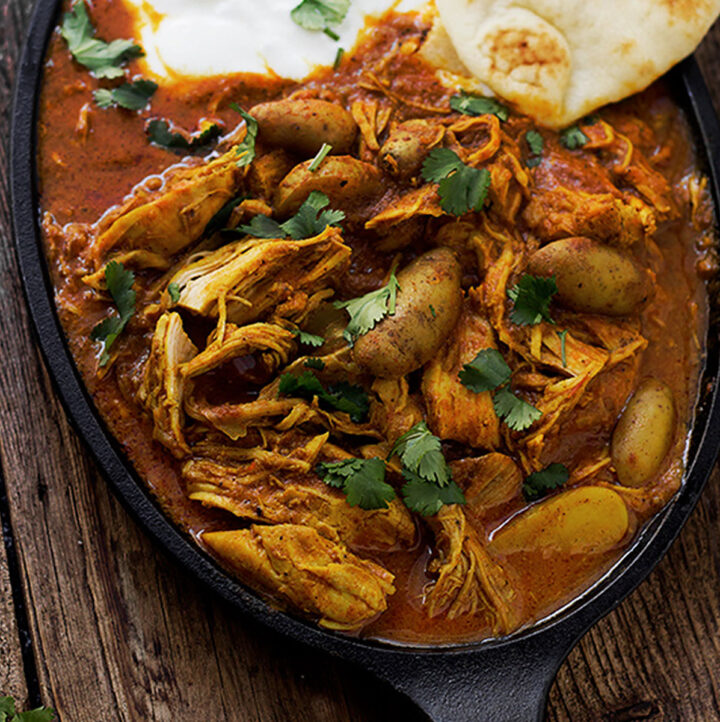 Indian spiced chicken with naan on cast iron dish