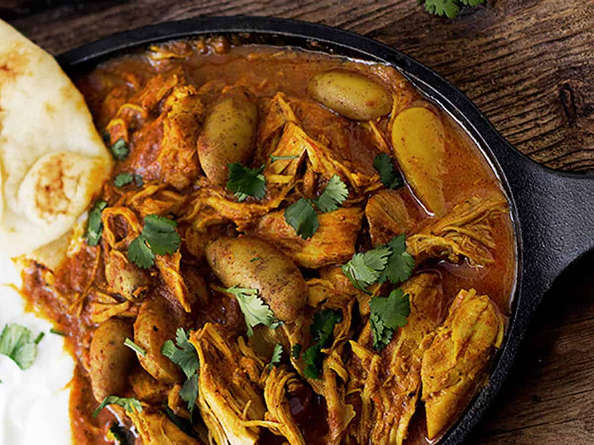 Indian spiced chicken with naan on cast iron dish