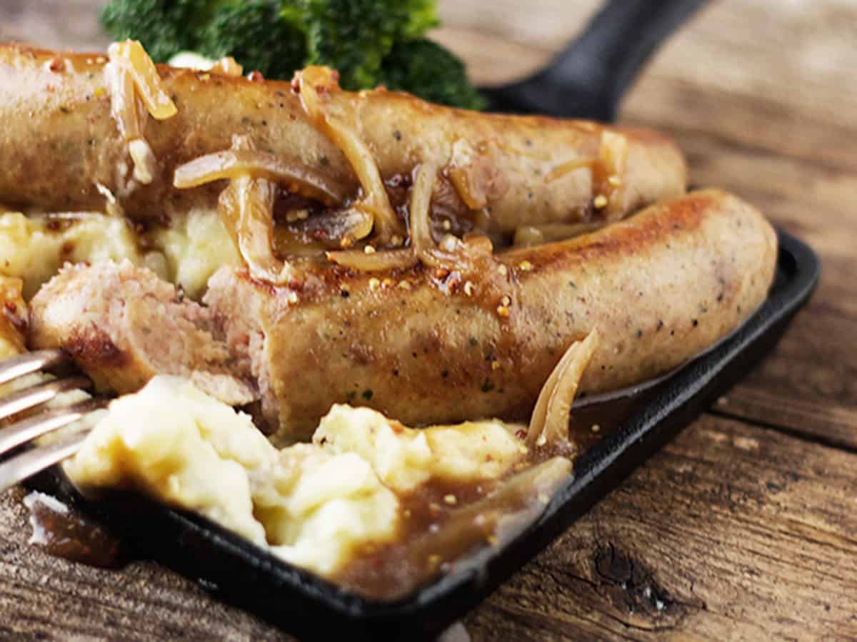bangers and mash with onion gravy on small skillet