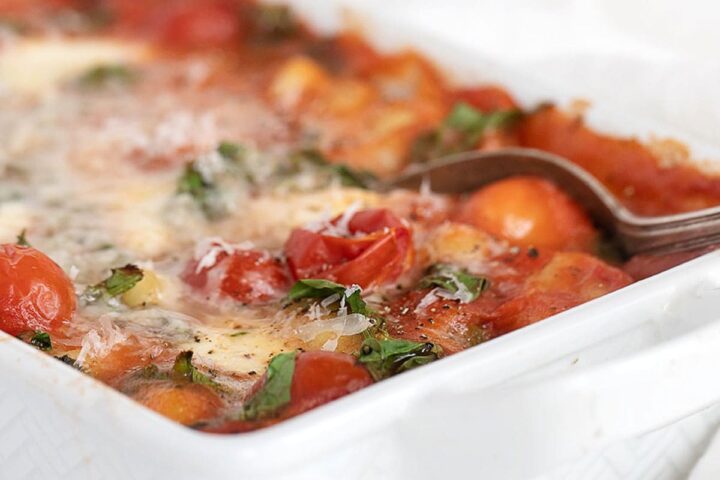 baked gnocchi with tomatoes and bocconcini in casserole dish