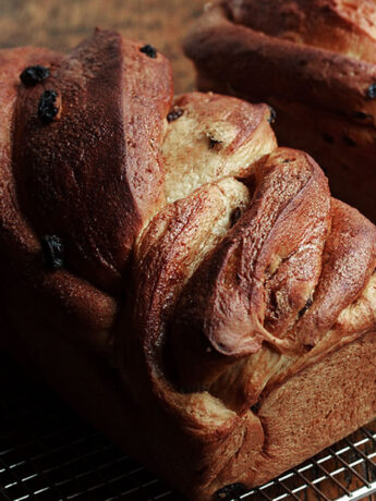 twisted cinnamon raisin bread on cooling rack