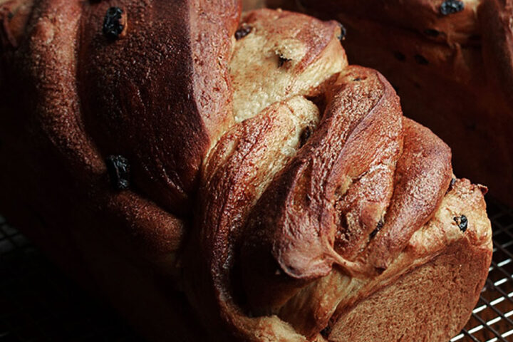 twisted cinnamon raisin bread on cooling rack
