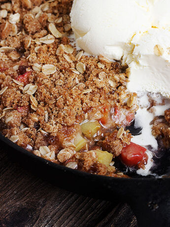 rhubarb crisp in skillet with ice cream