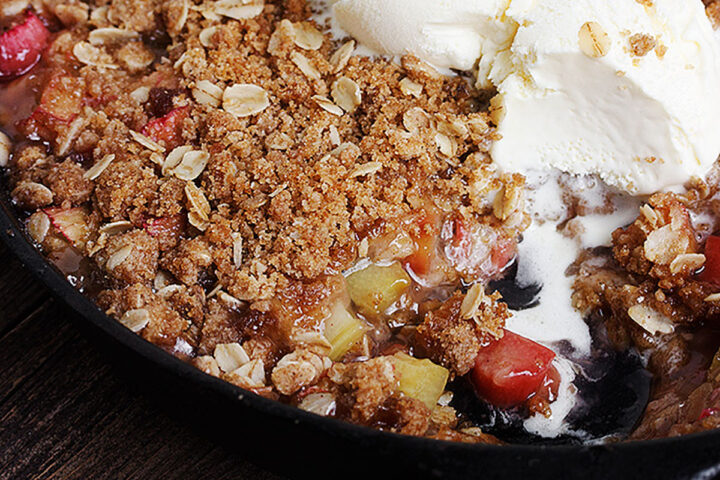 rhubarb crisp in skillet with ice cream